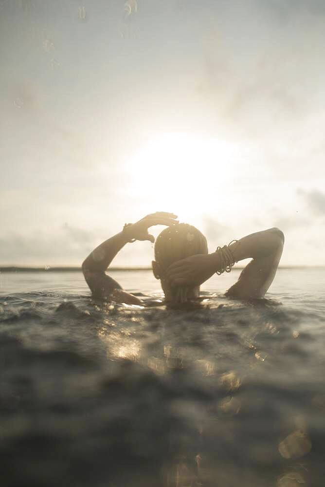 Caucasian woman swimming in still lake