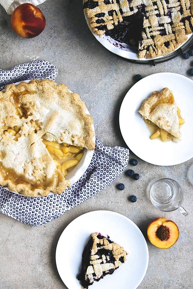 Plates of peach and blueberry pies