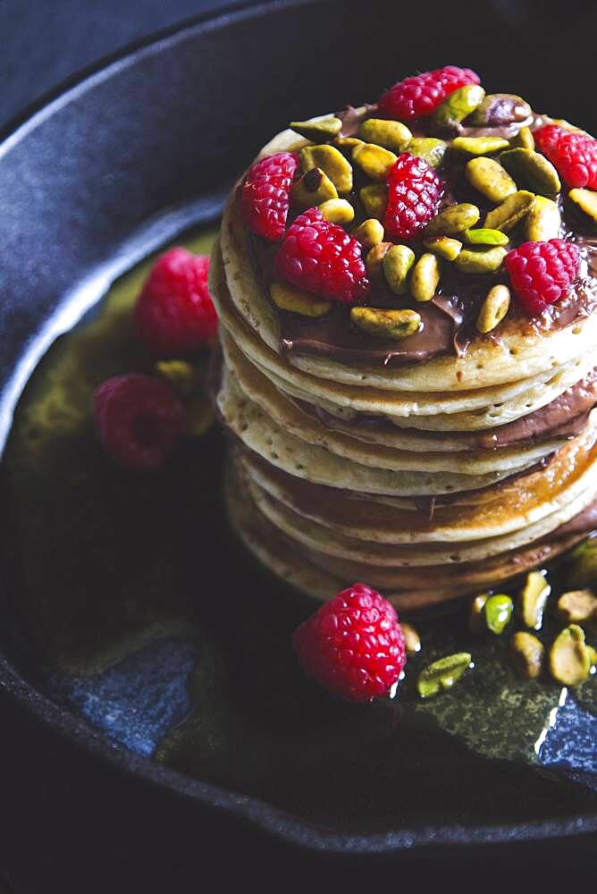 Pistachios and raspberries on pancakes