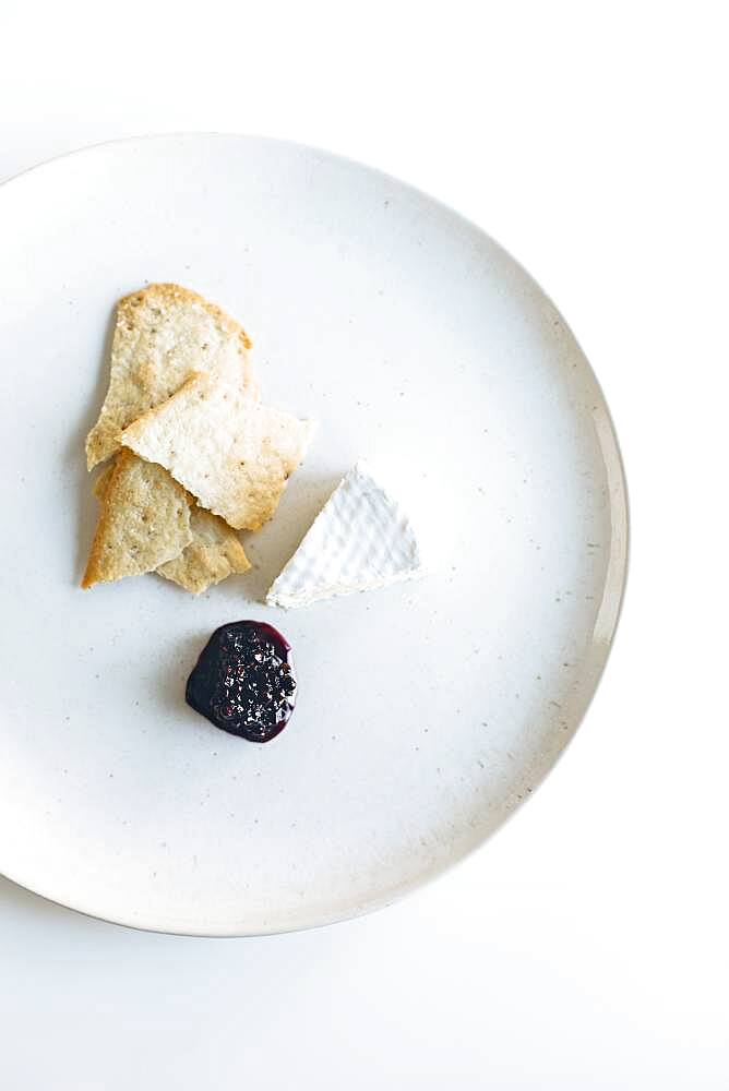 Plate of brie cheese, jam and crackers