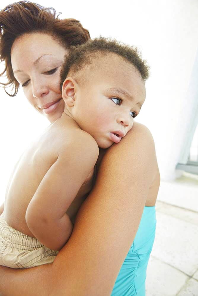 Close up of Black mother comforting son