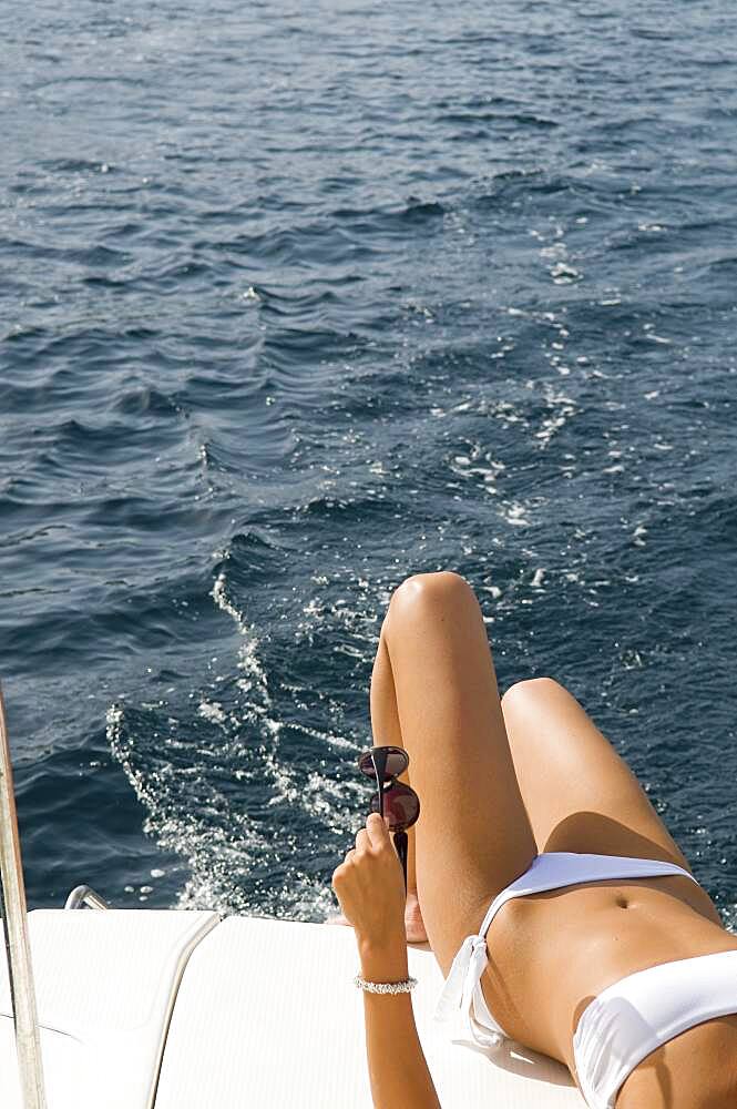 Woman wearing bikini on boat deck