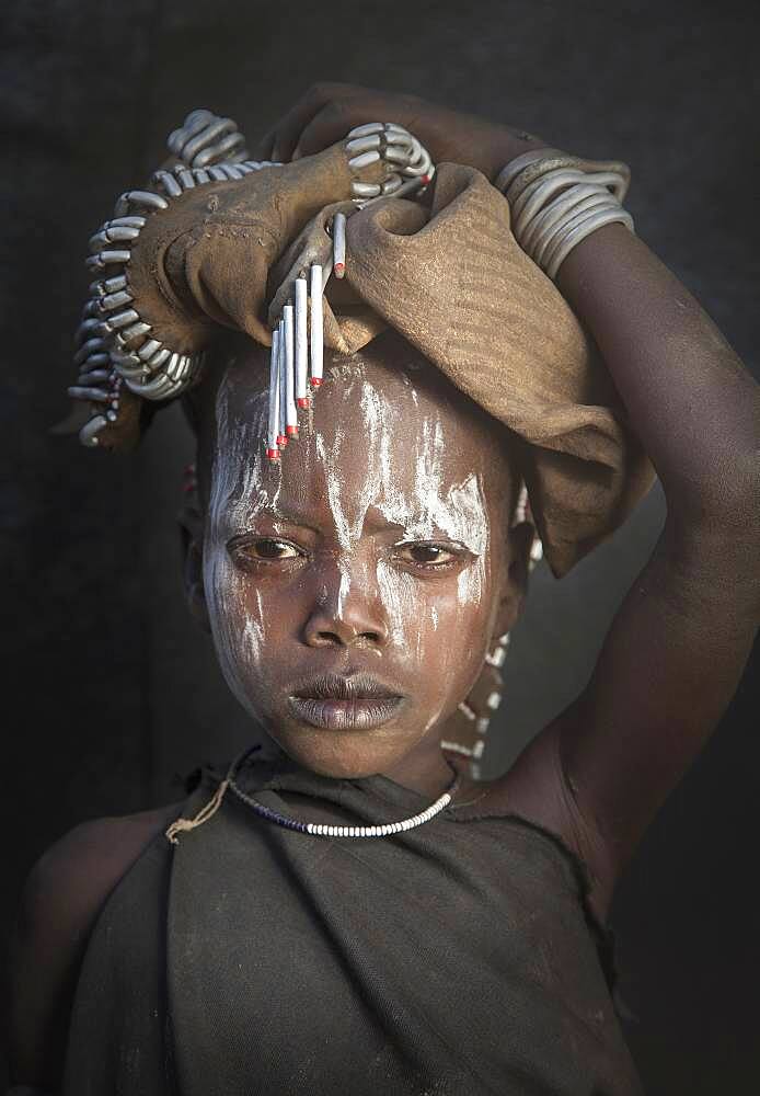 Black child wearing traditional face paint