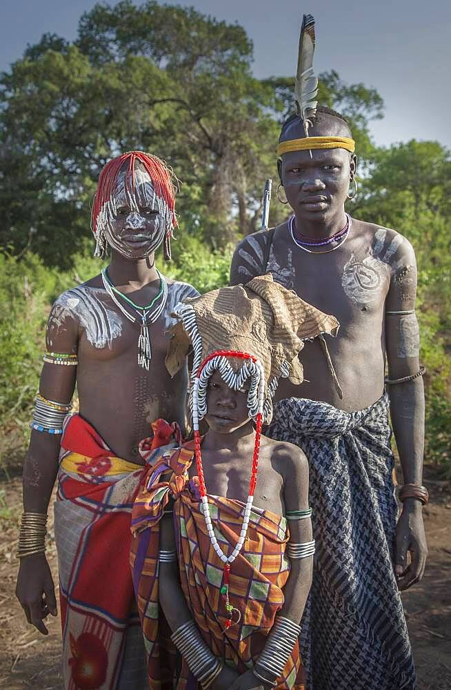 Black father and teenage children in traditional clothing