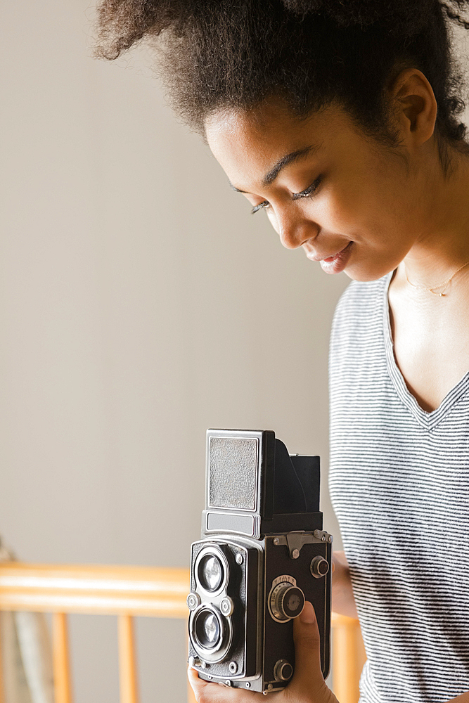 African American woman using old-fashioned camera