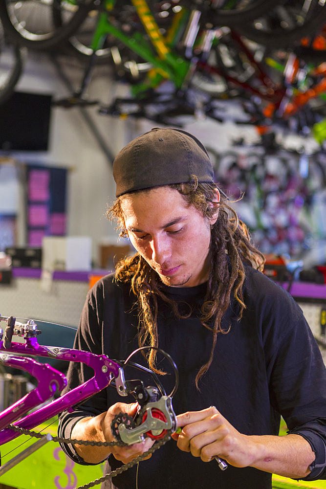 Man repairing bicycle in shop