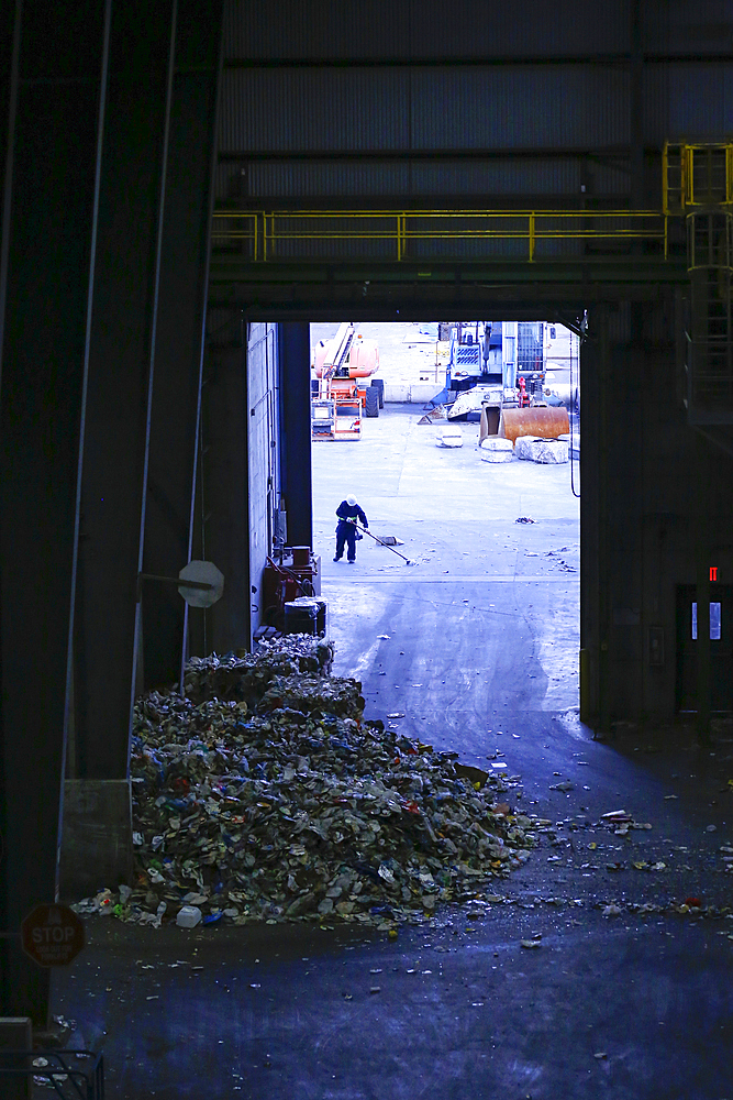 Man sweeping garbage with broom