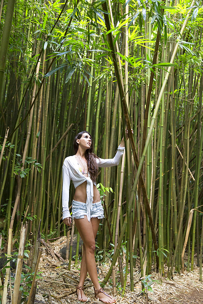 Caucasian woman standing in bamboo forest