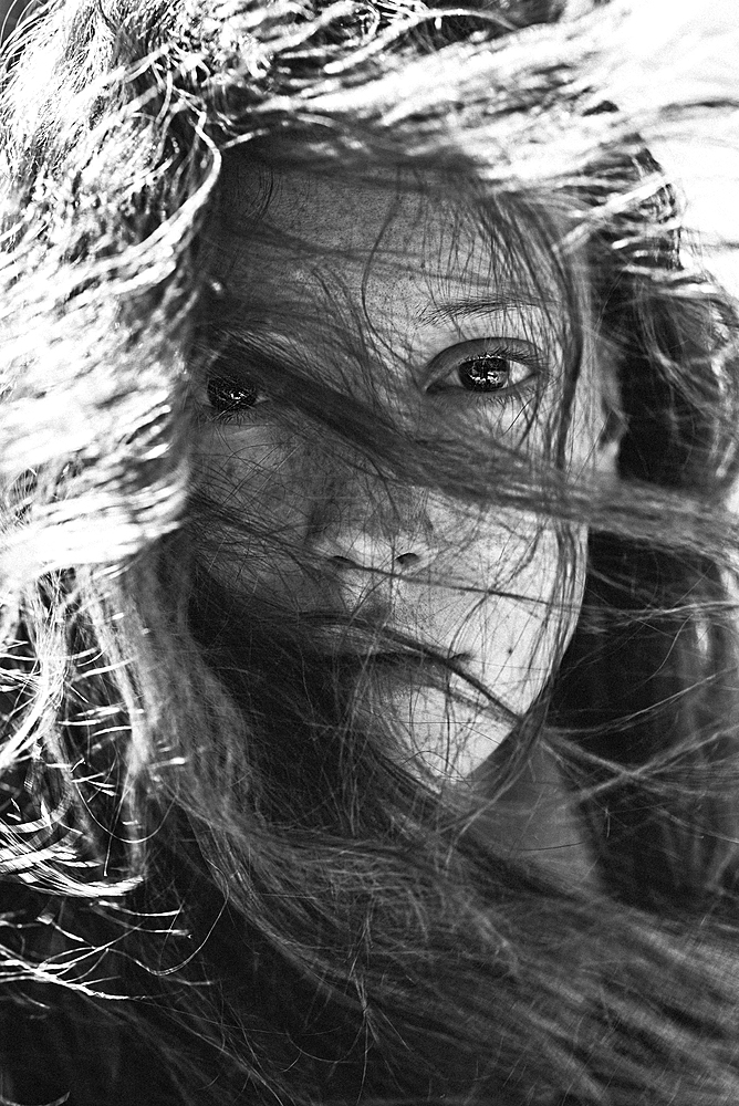 Wind blowing hair of Caucasian woman