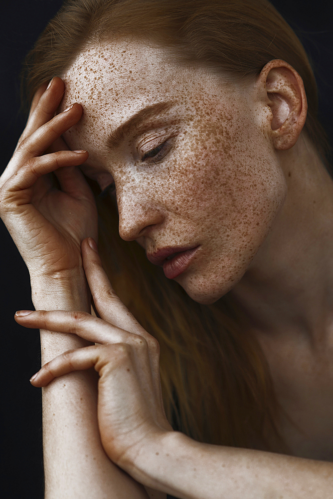 Close up of pensive Caucasian woman with freckles