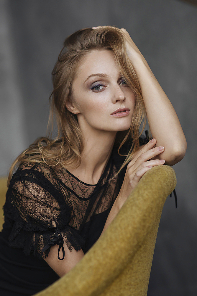 Portrait of glamorous Caucasian woman sitting on sofa