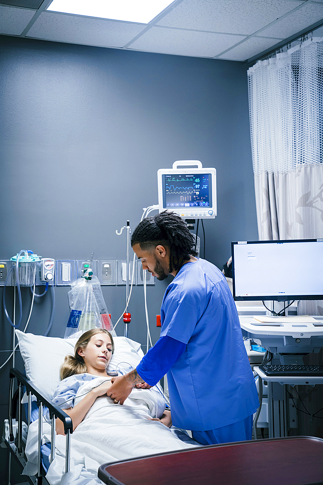 Nurse holding hand of patient in hospital