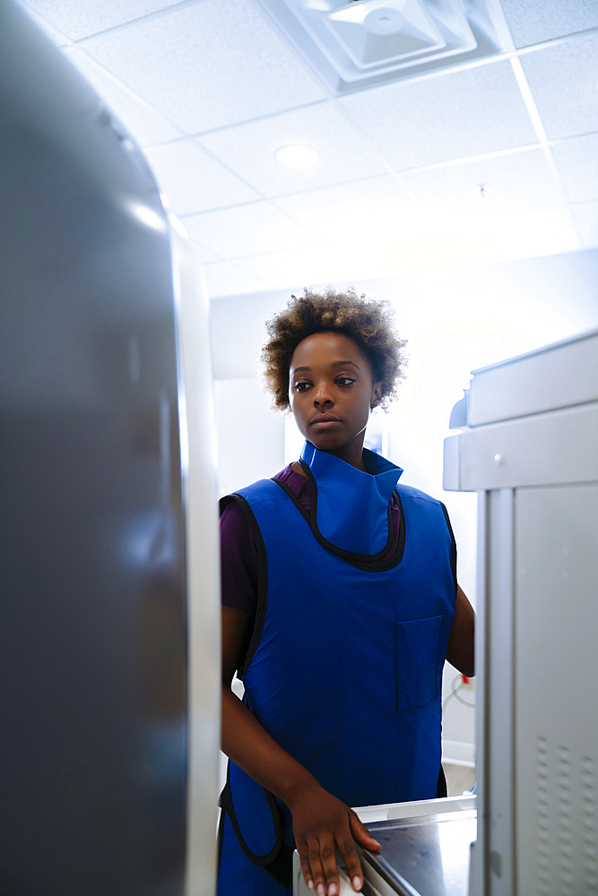 Black hospital technician wearing protective vest