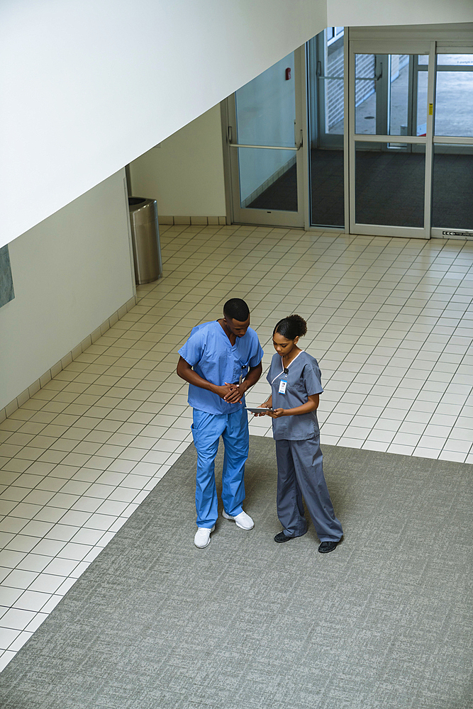 Nurses discussing digital tablet