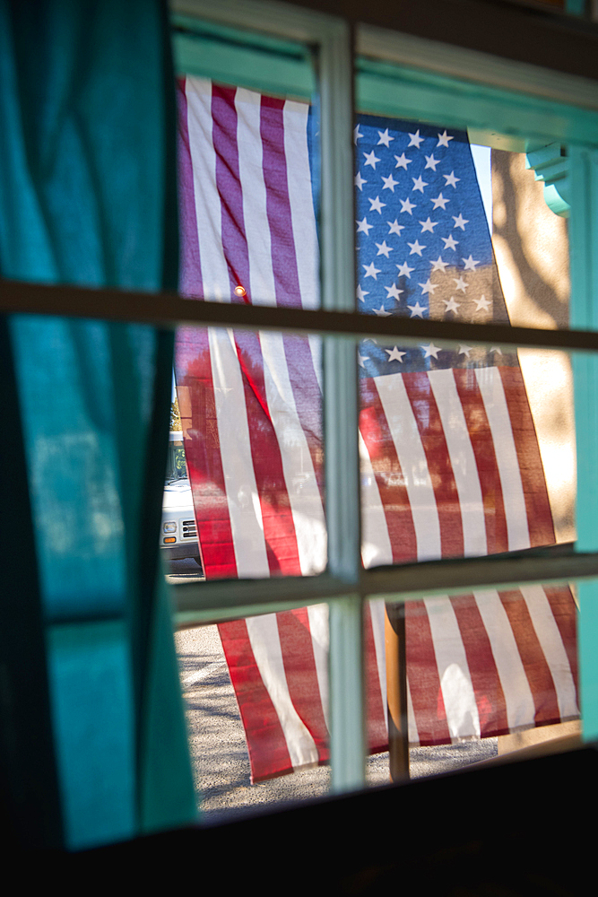 American flag hanging outside window