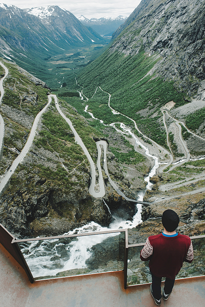 Caucasian man standing at viewpoint admiring scenic view of valley