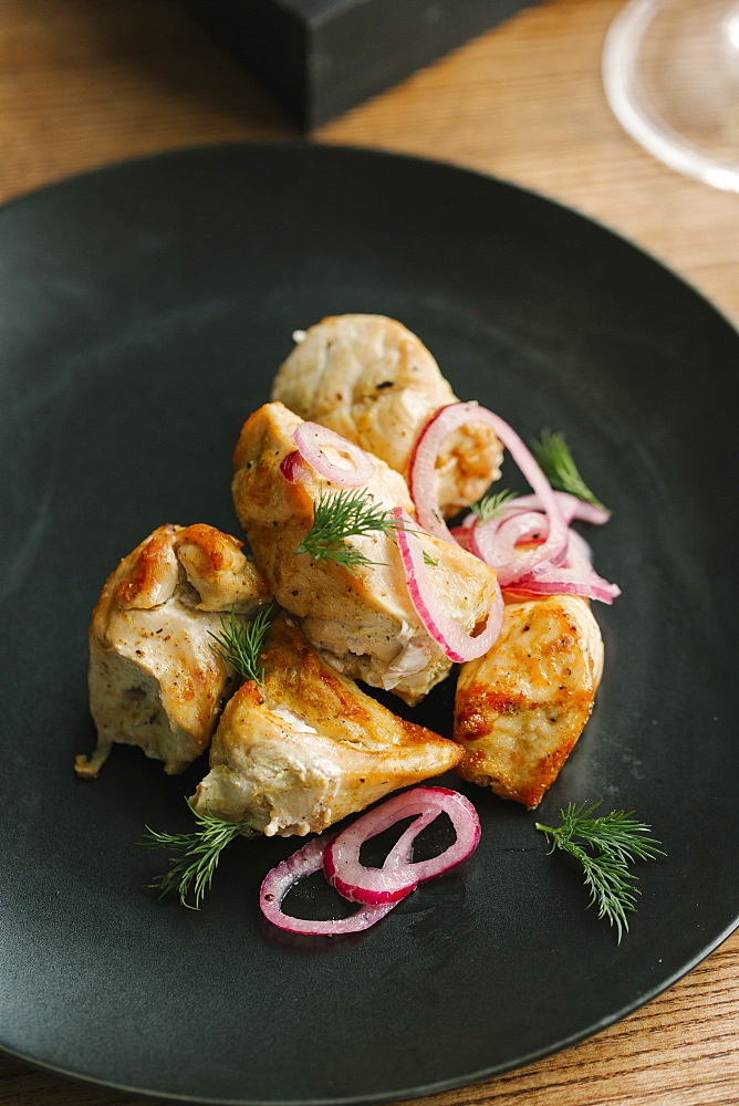 Chicken on plate with onions and garnish