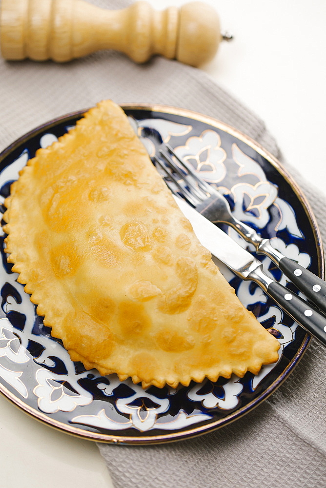 Pastry on plate with fork and knife