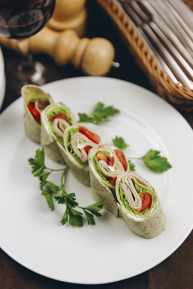 Slices of rolled sandwich on plate