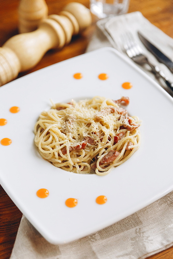 Plate of pasta on table