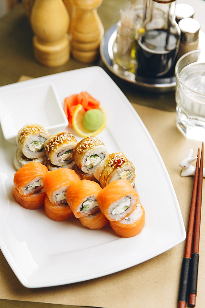 Sushi on plate with chopsticks