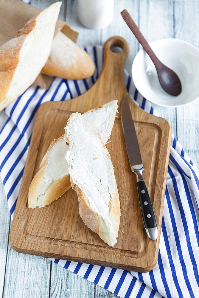 Bread with butter on cutting board