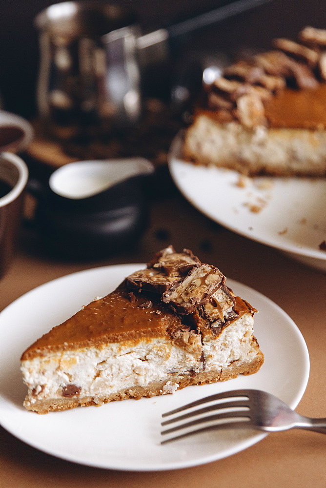 Slice of cheesecake on plate with fork