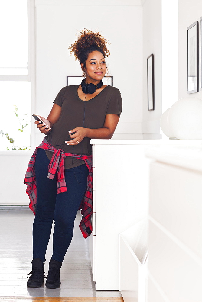 Mixed race woman holding cell phone