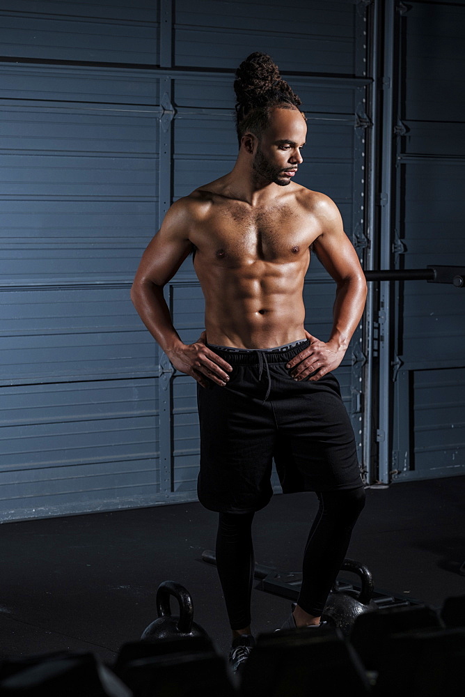 Mixed Race man resting in gymnasium