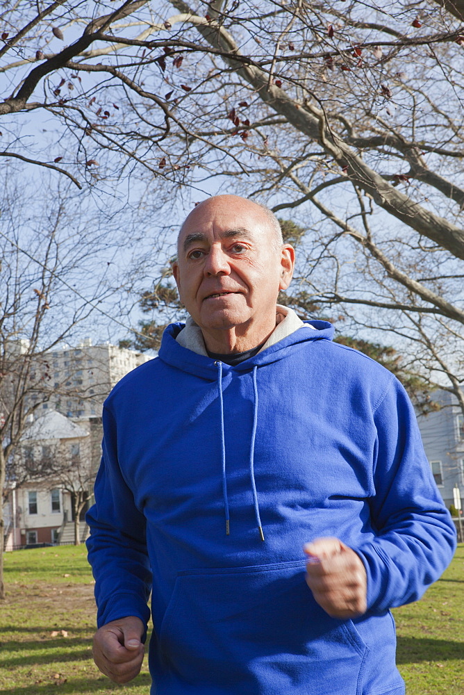 Hispanic man jogging in park