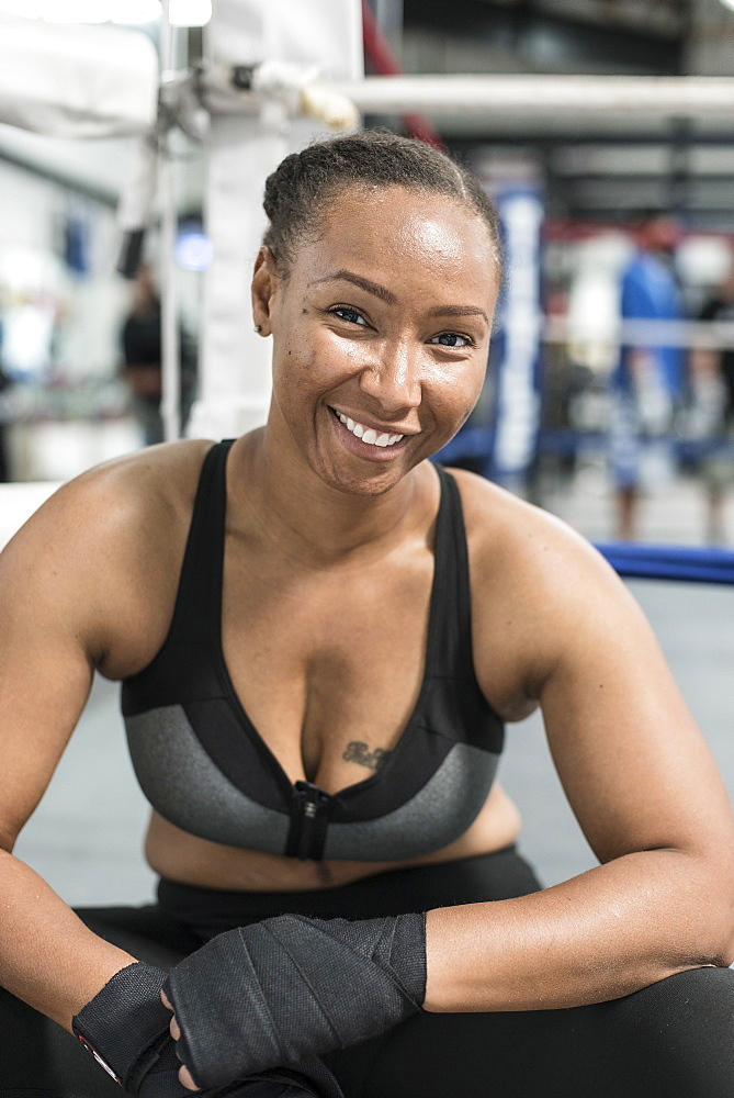 Black woman with wrapped hands in gymnasium