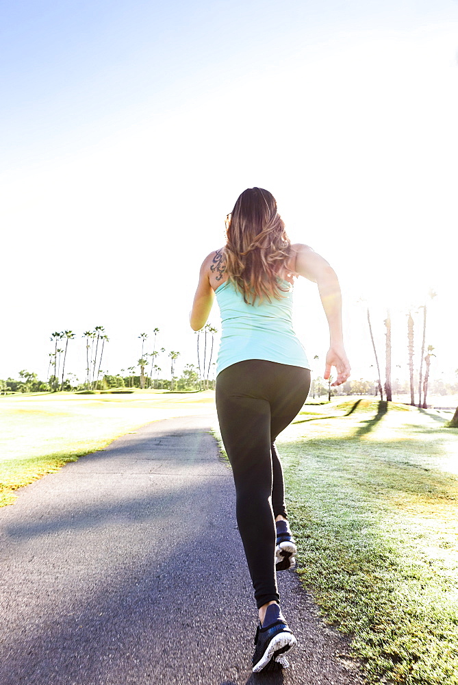 Hispanic woman running on path