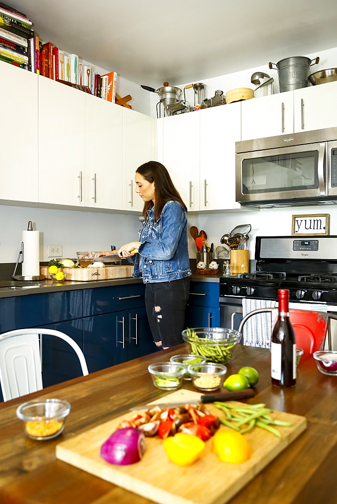 Woman chopping vegetables in kitchen