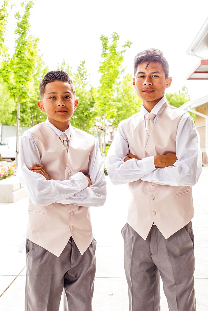 Portrait of confident Hispanic boys wearing suits