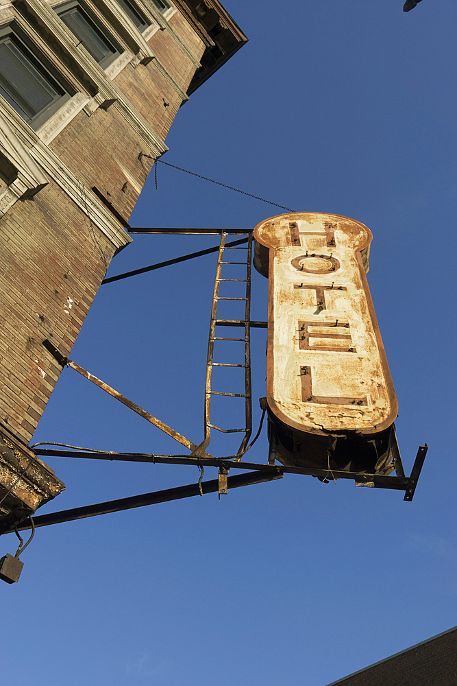 Decrepit hotel sign on building