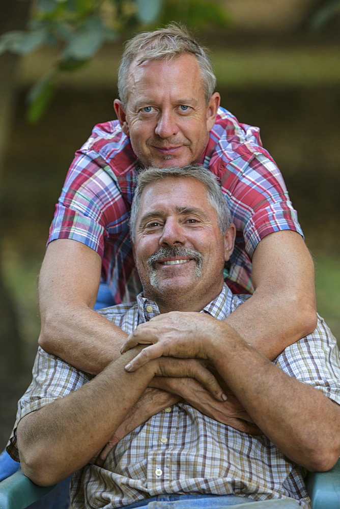 Portrait of smiling Caucasian men hugging