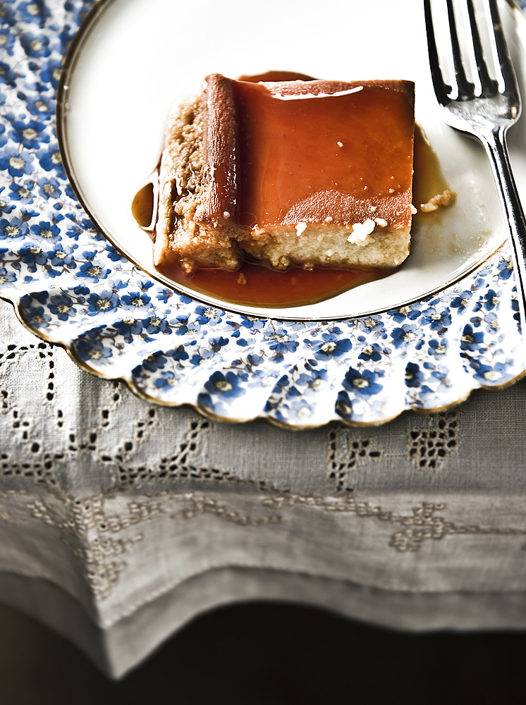 Flan on plate with syrup and fork