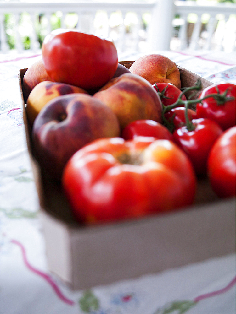 Box of fresh tomatoes and peaches