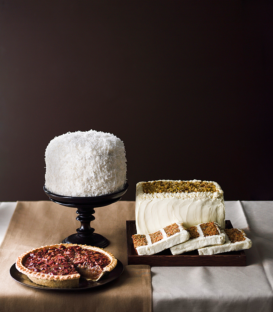 Cakes and pie on table