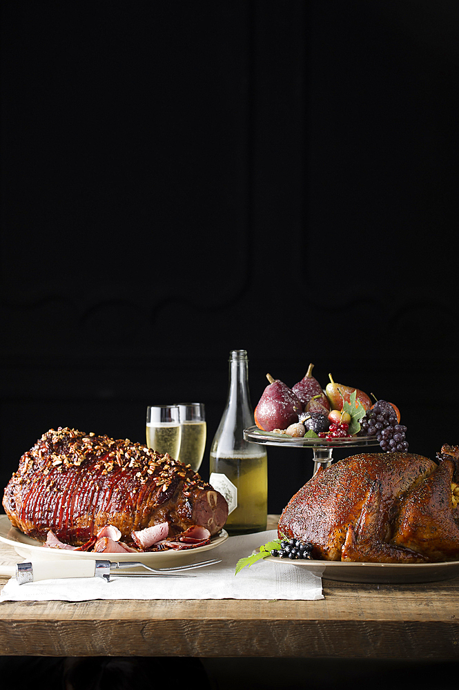 Champagne, fruit and meat on wooden table