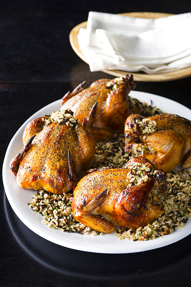 Cornish hens on plate with rice