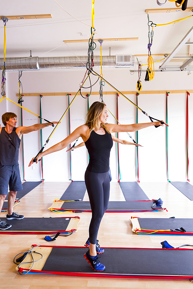 People using resistance bands in gymnasium