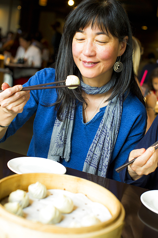 Japanese woman eating food with chopsticks