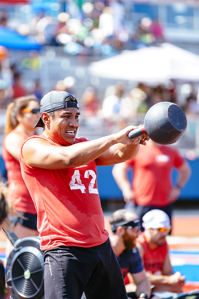 Man lifting kettlebell outdoors