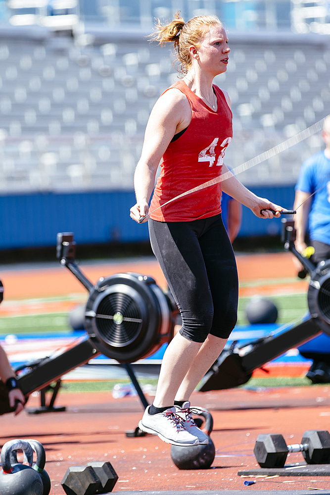 Caucasian woman jumping rope outdoors