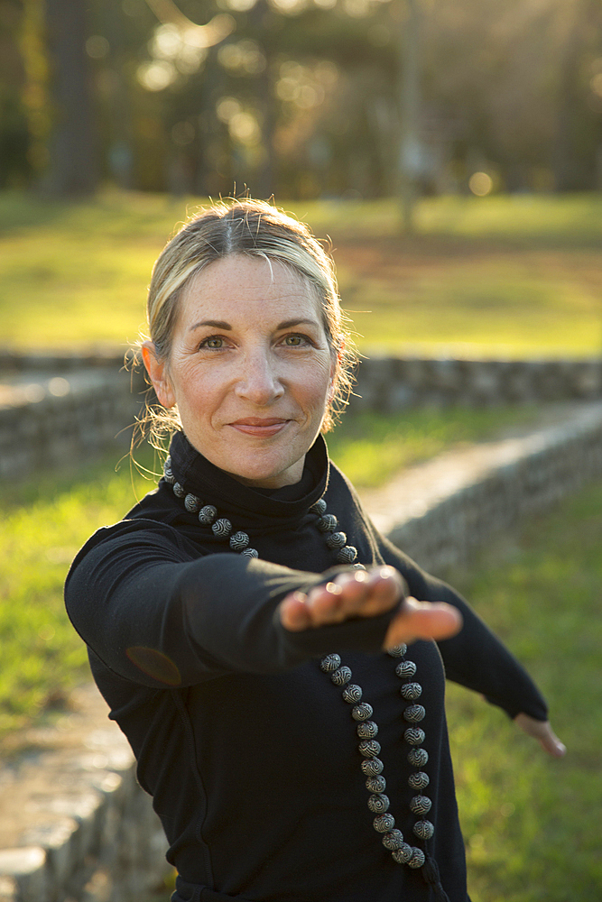 Portrait of Caucasian woman practicing yoga in park