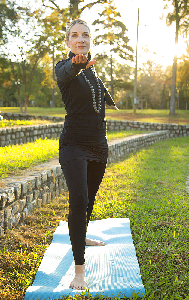 Caucasian woman practicing yoga in park