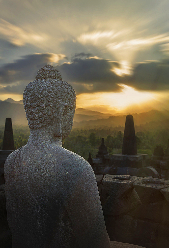 Statue of Buddha at sunset, Borobudur, Java, Indonesia