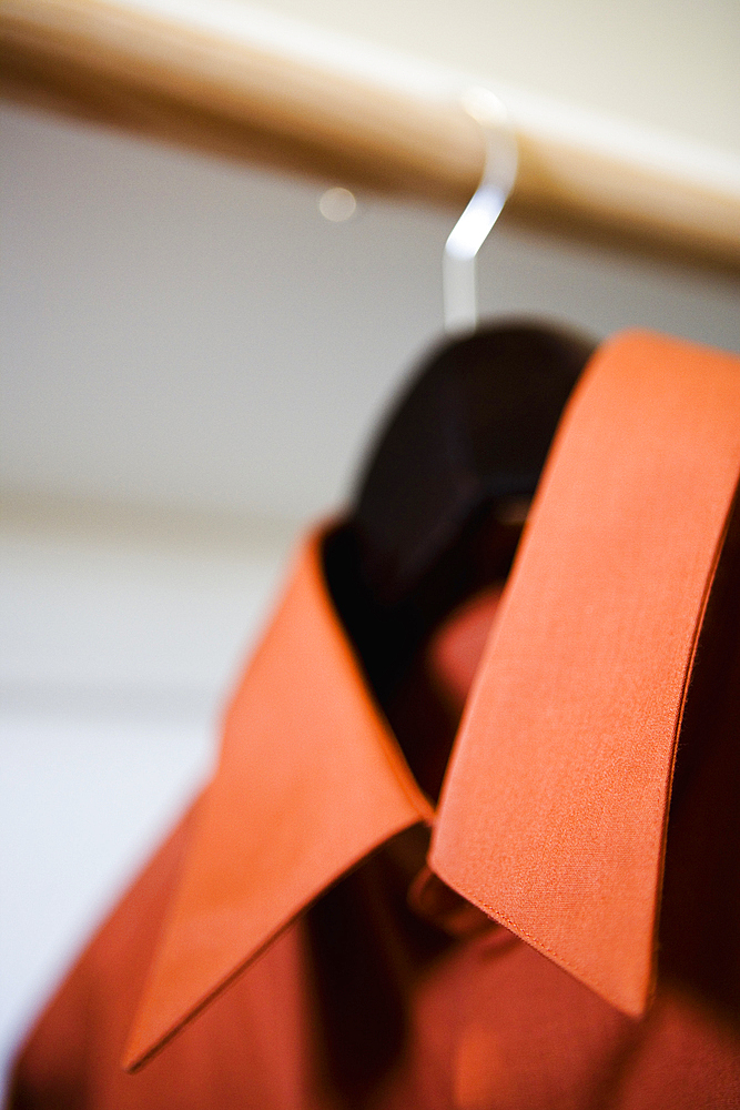 Red Collared Dress Shirt Hanging in Closet