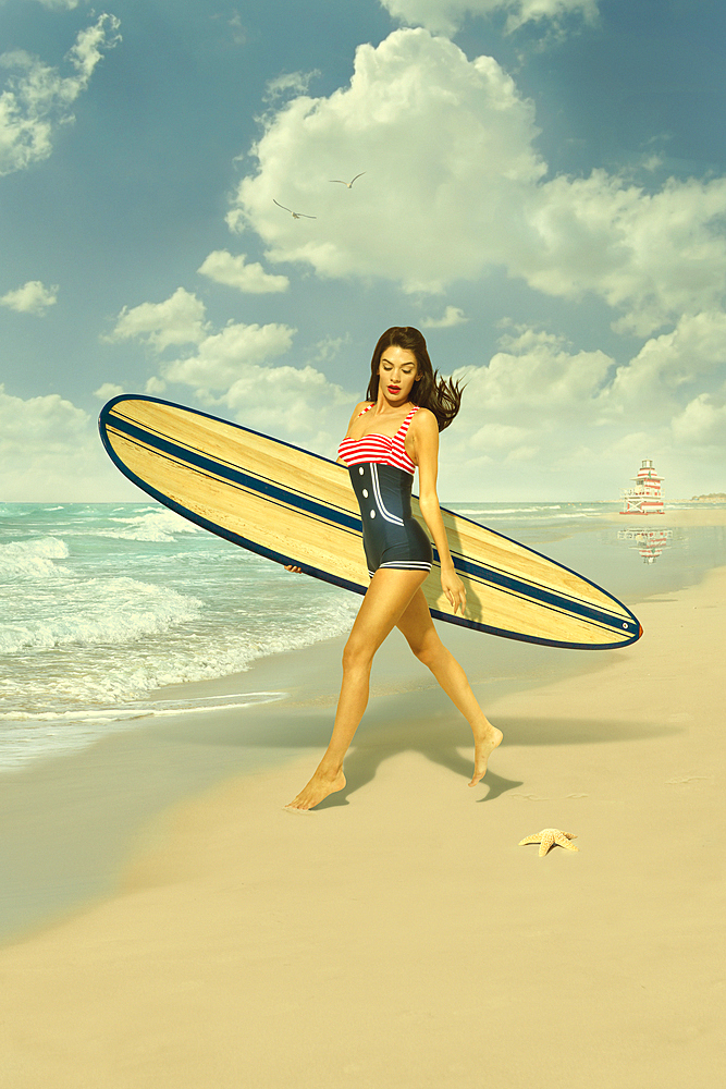 Caucasian woman running on beach carrying surfboard